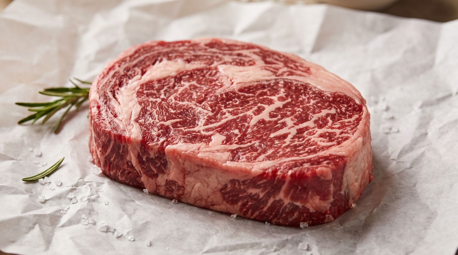 The Best Meat for Keto and Carnivore Diet Isn't Just Steak 2 Close-up of grass-fed beef with visible white marbling laid on butcher's paper, illustrating the fat content prized on a keto and carnivore diet